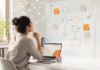 AI and Software Development Jobs in 2026: 5 Roles That Are Growing and How to Stay Hireable Software developer turning from a laptop keyboard toward a planning board, representing the shift in software jobs as AI changes the work in 2026.